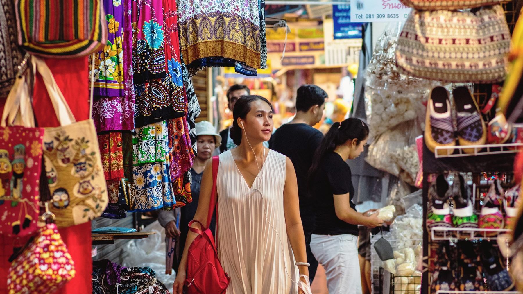 Shoppers browsing market stalls