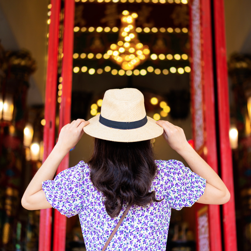 A visitor exploring a temple entrance
