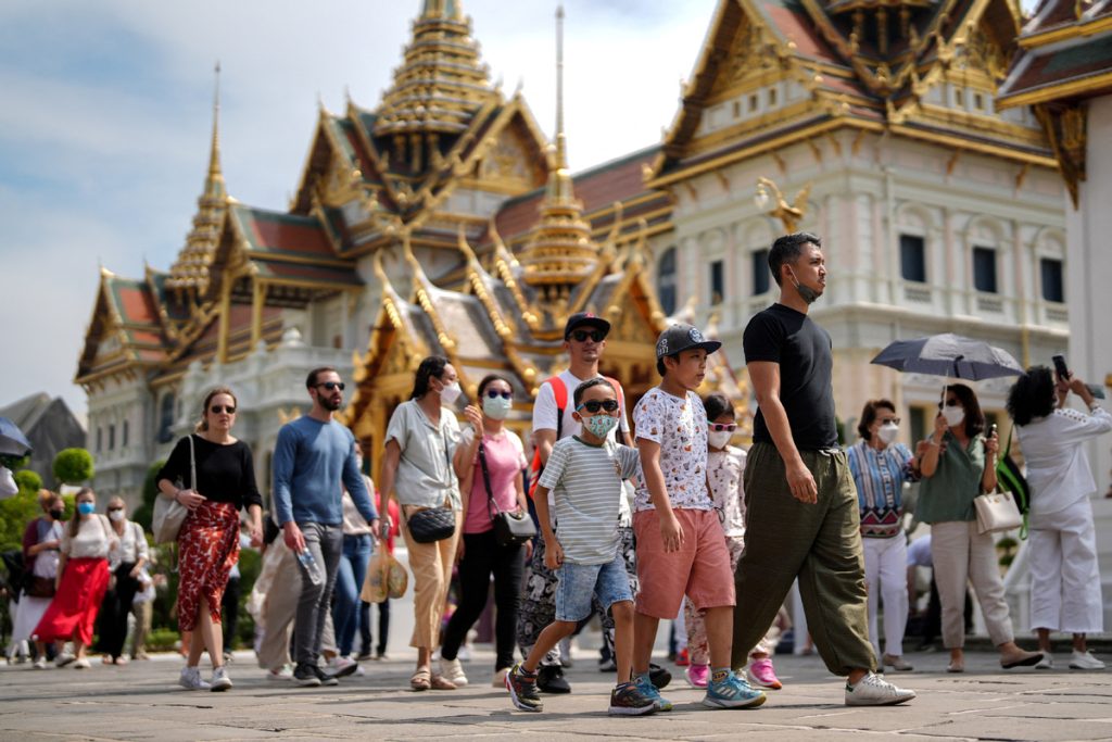 Visitors wearing modest clothing at a Thai temple